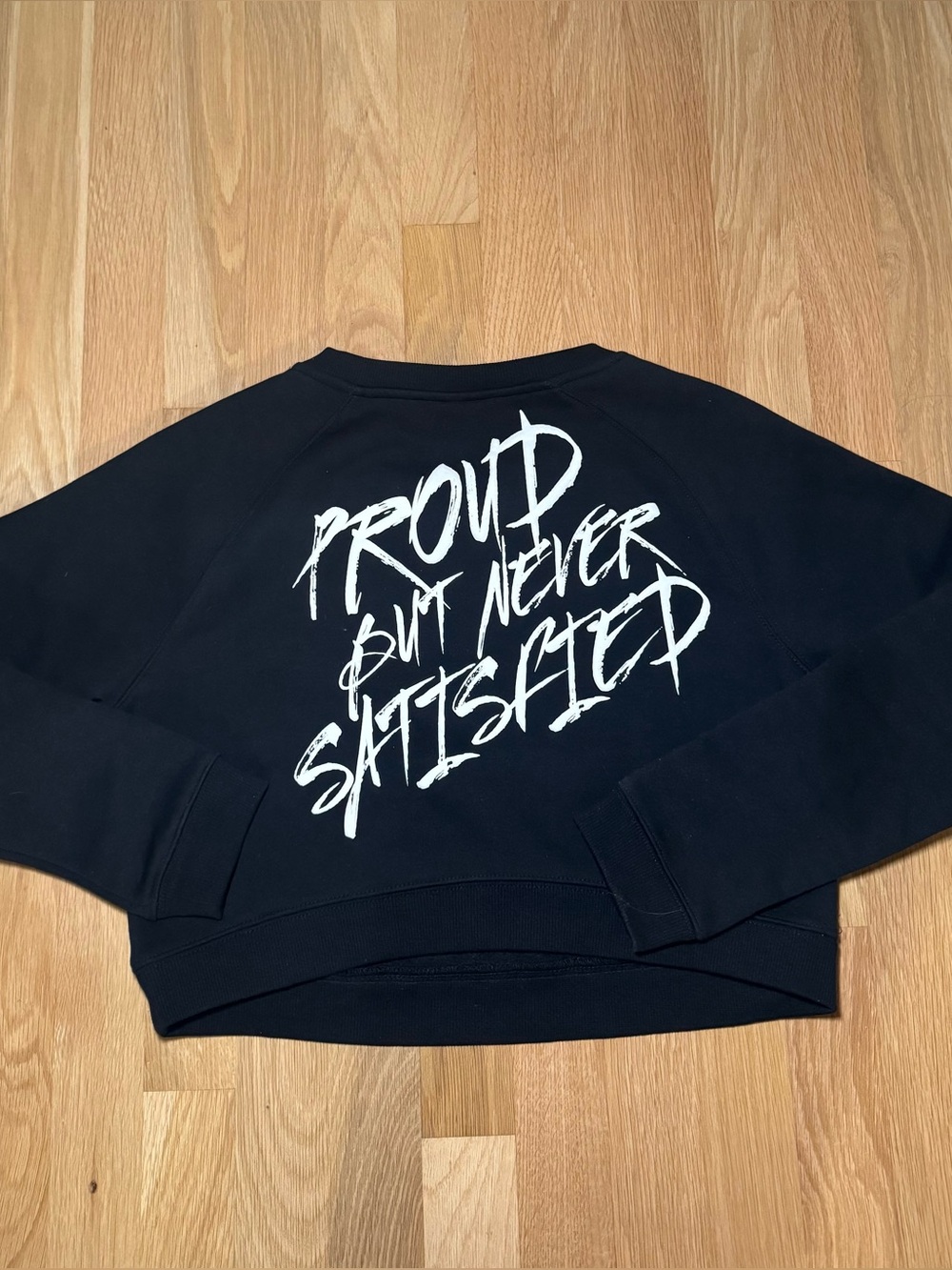 ALPHALETE- Black Graphic Crewneck Sweater - 'Proud But Never Satisfied'